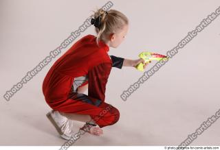 DENISA SITTING POSE WITH GUN